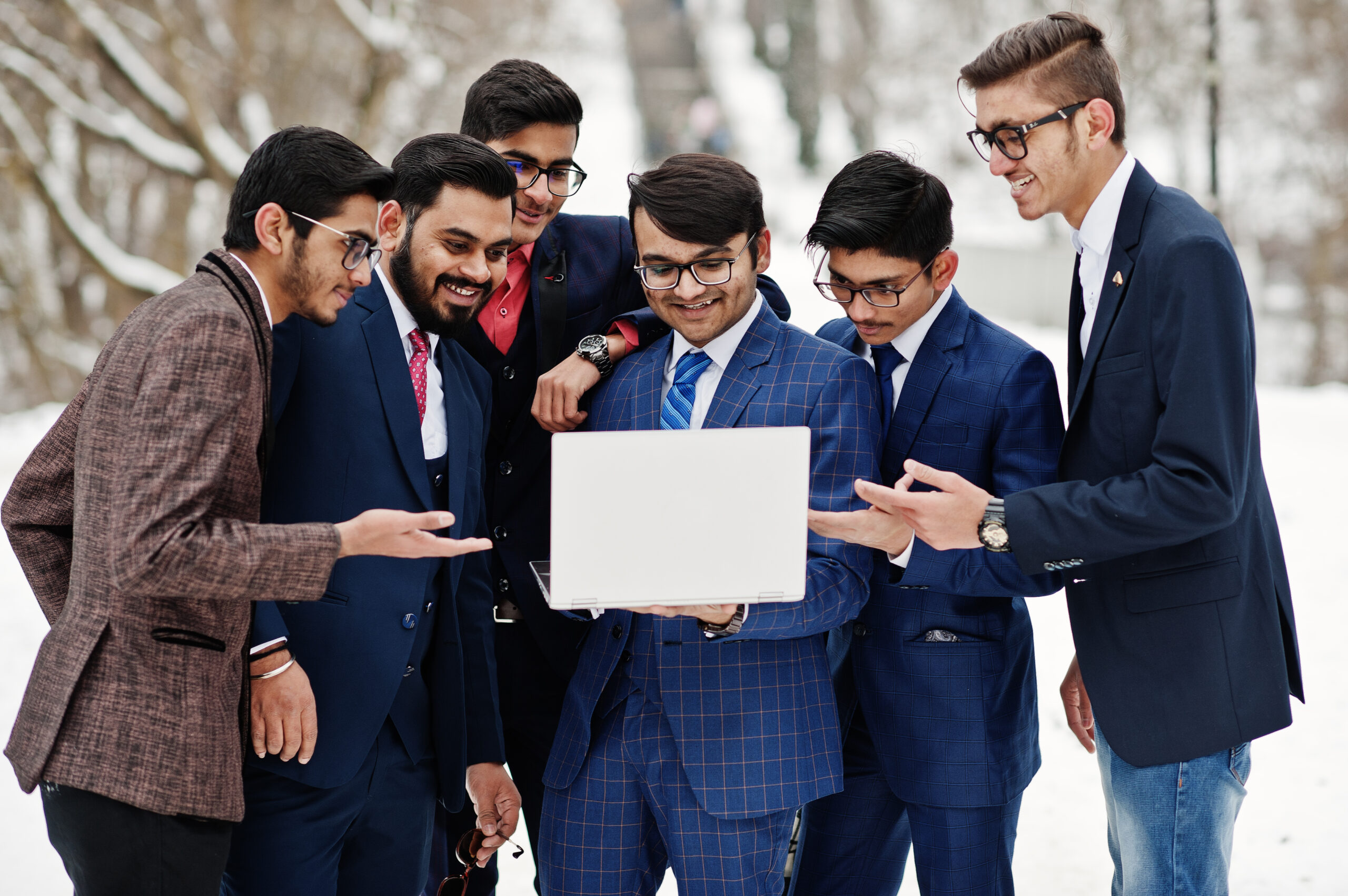 group-six-indian-businessman-suits-posed-outdoor-winter-day-europe-looking-laptop-scaled.jpg